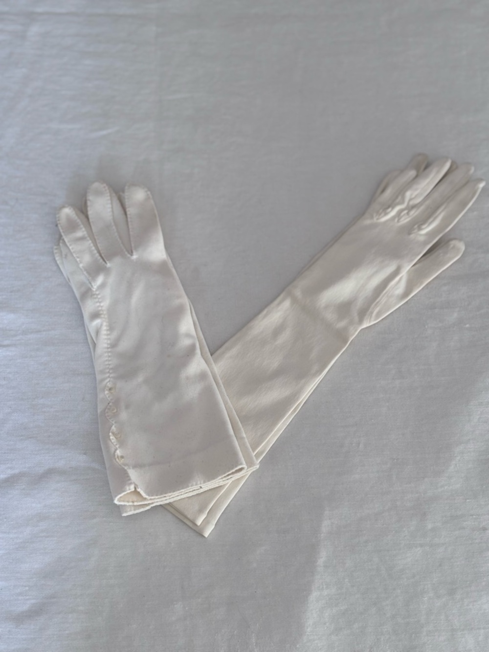 Two pairs vintage Ladies White Gloves. One has buttons